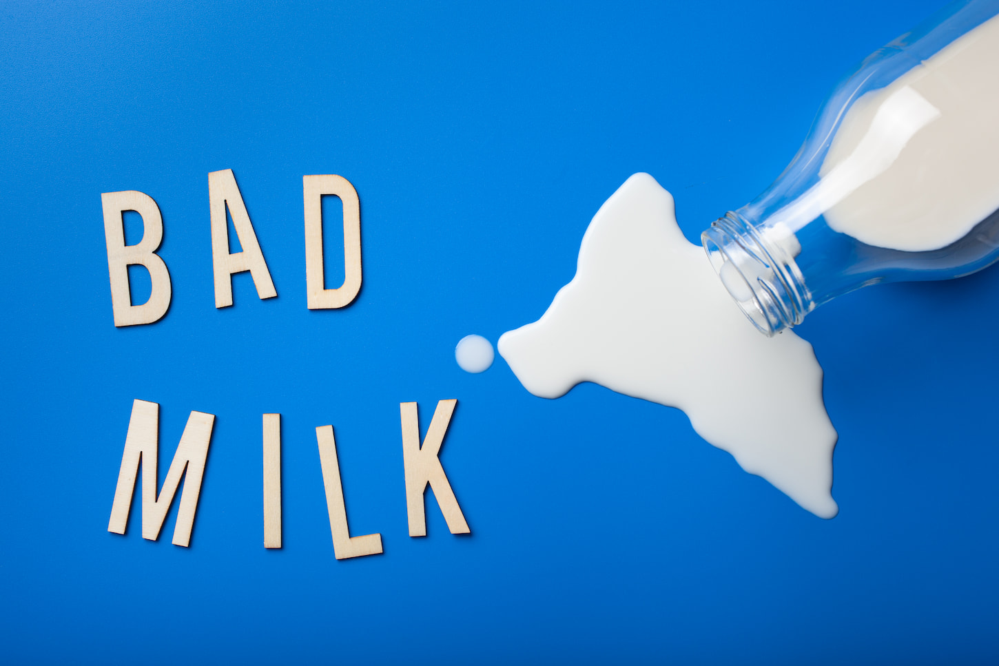 An image of bad milk word text letters in milk splatter.