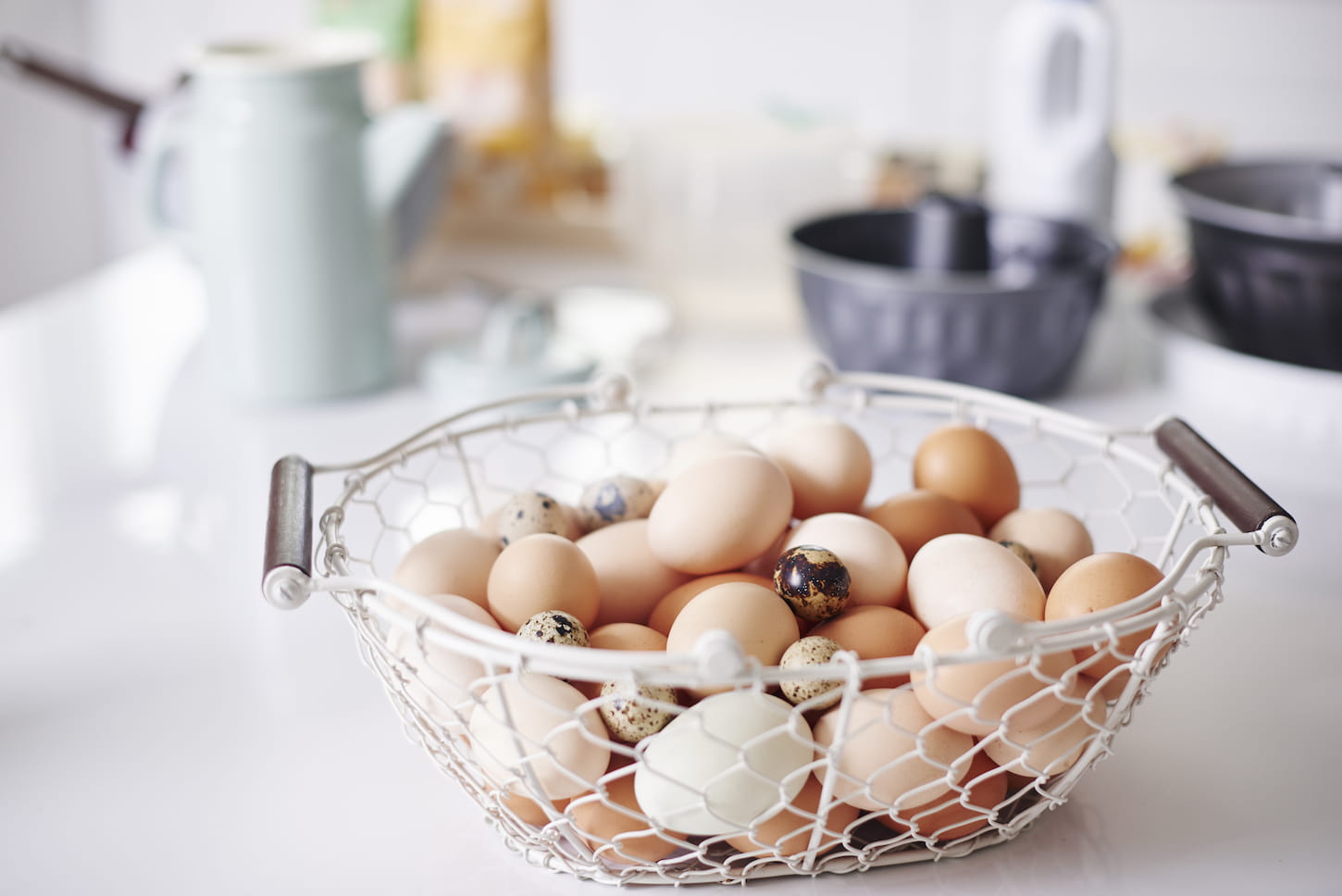 An image of a basket full of eggs on the kitchen counter.