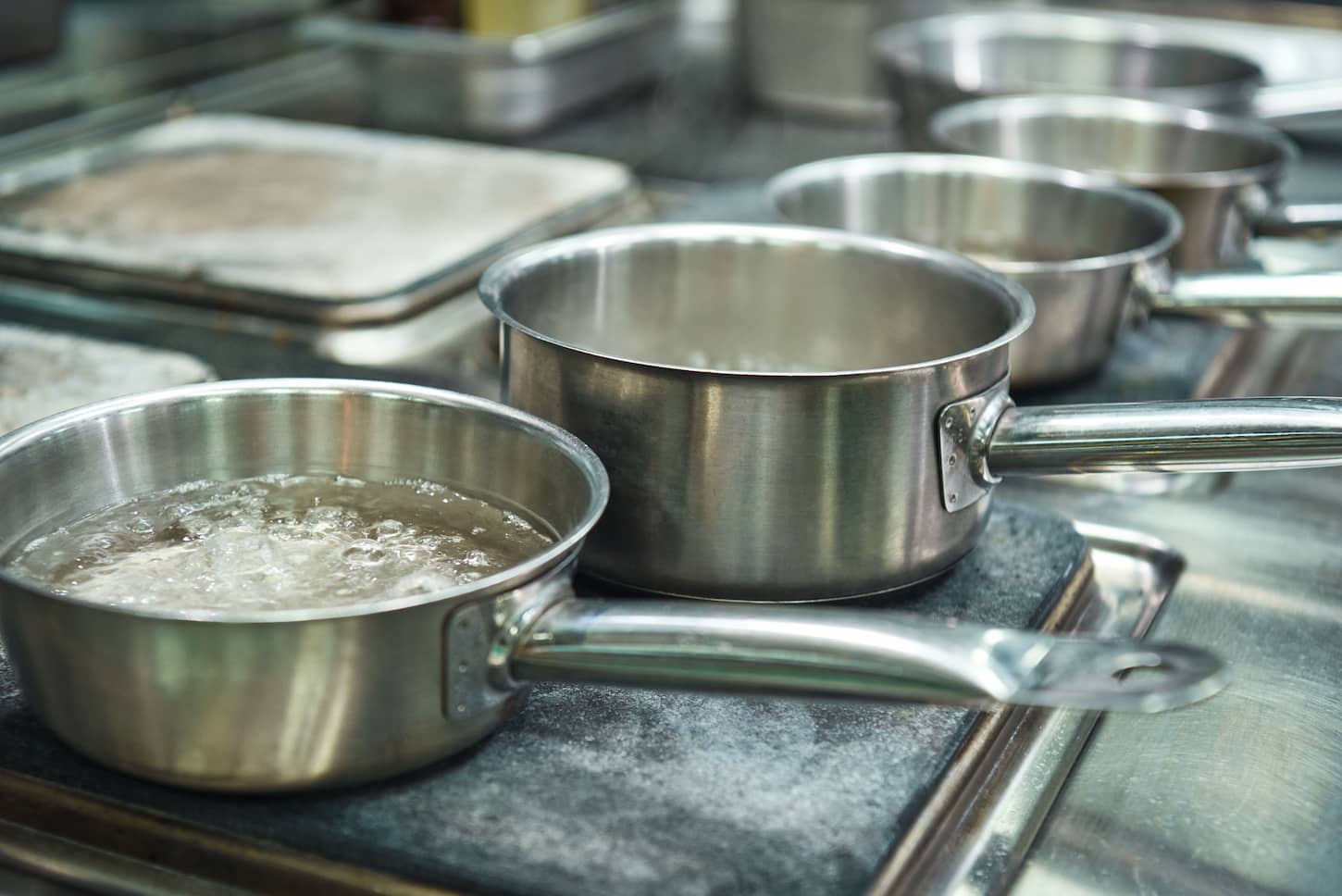 An image of boiling water in a metal pan for pasta cooking.