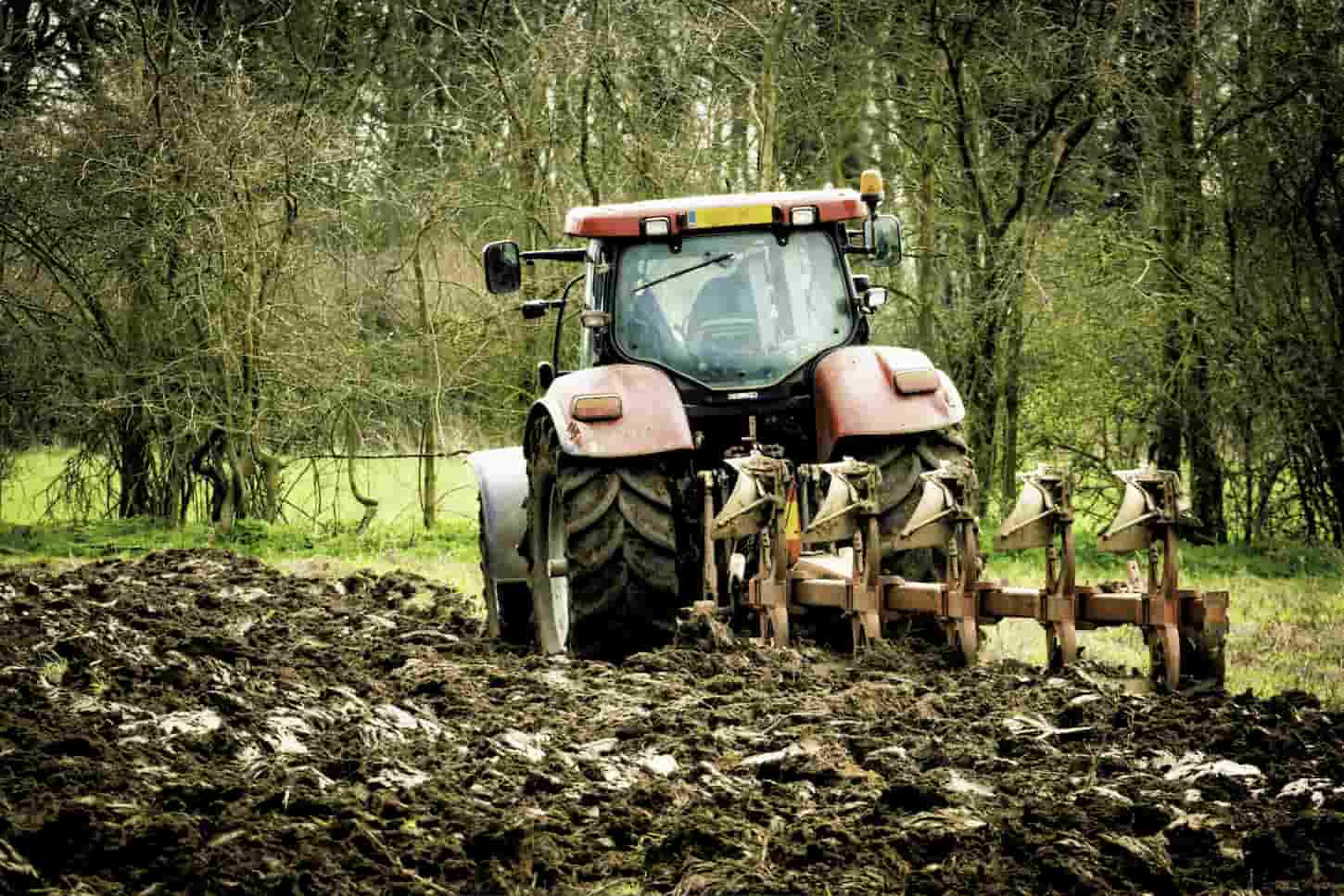 An image of Agricultural tractor ploughing field