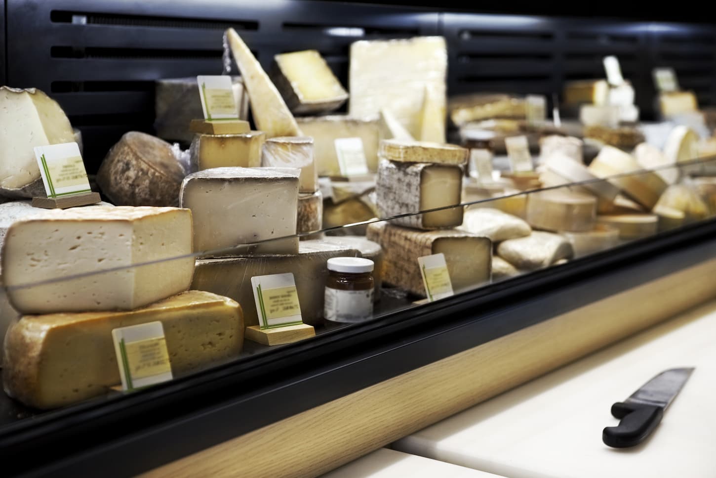 An image of a Cheese stall inside a French dairy store.