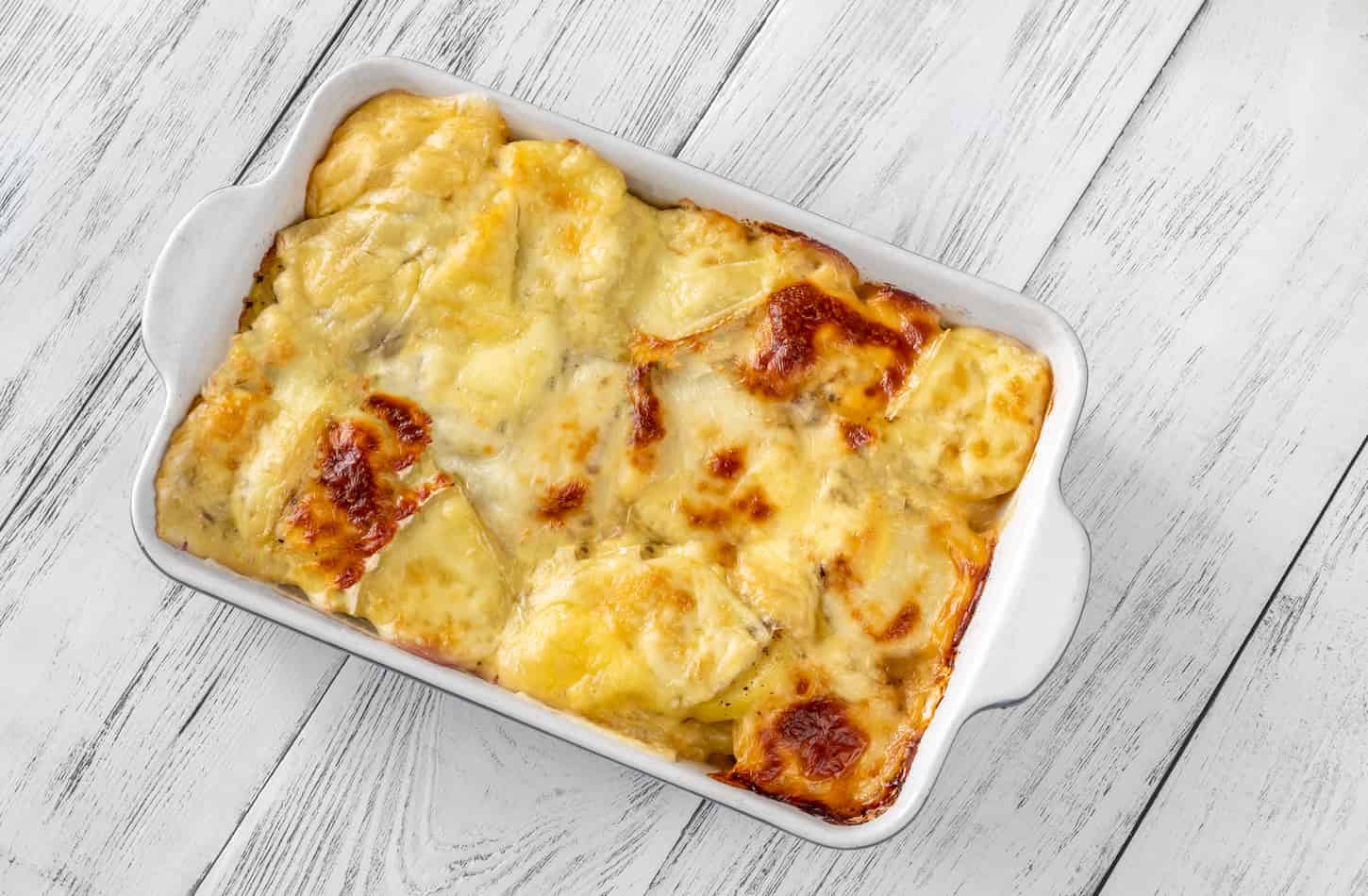 An image of Tartiflette - a French casserole dish made with potatoes, reblochon cheese, lardons, and onions.