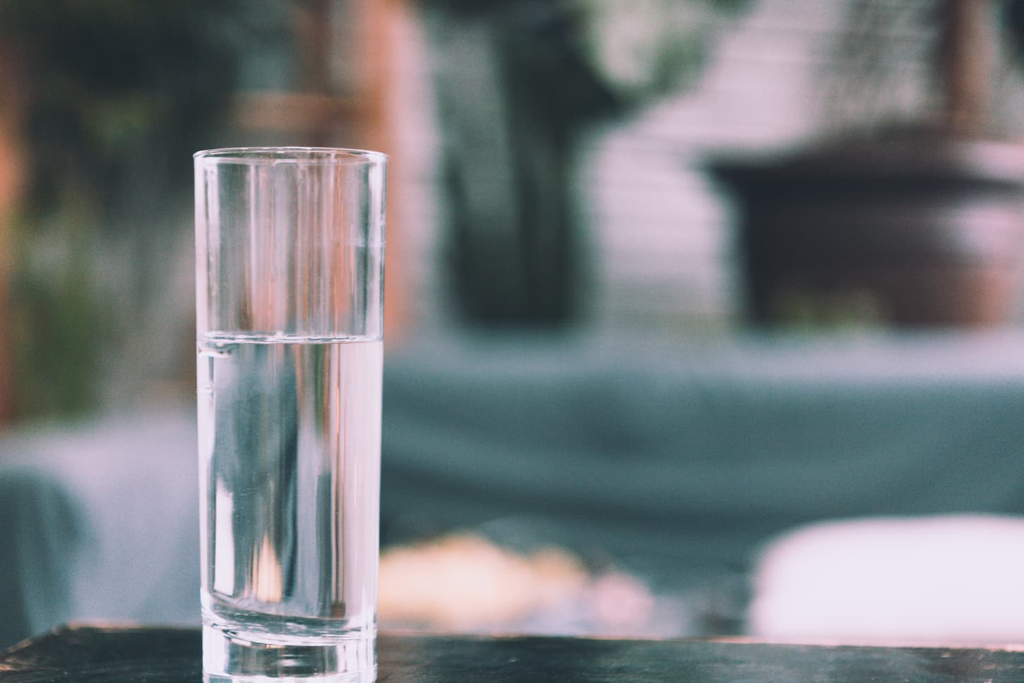 An image of a Glass of water on a wooden table.