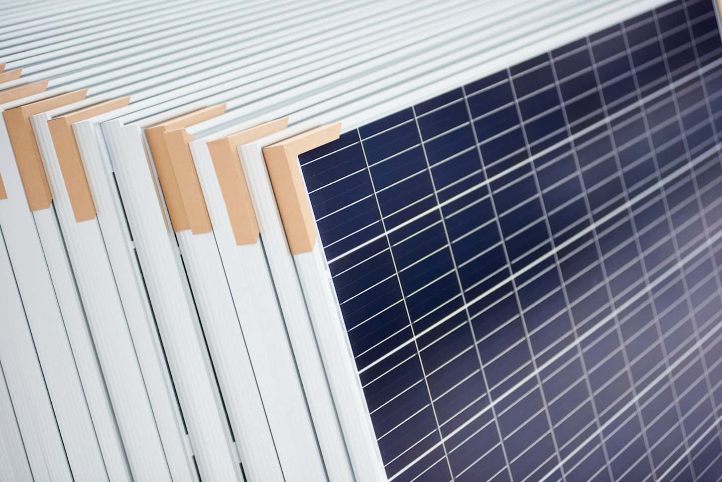 An image of an Alternative electricity source. Stack of photovoltaic solar panels. Renewable energy production modules blue modern sustainable resources ecological power plant.