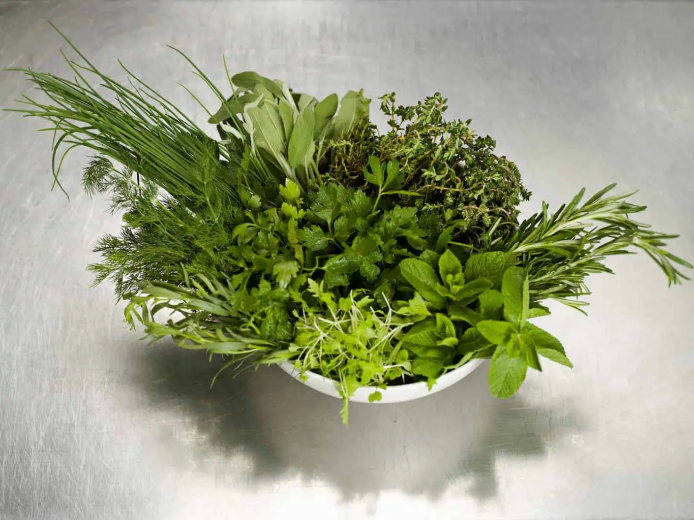 An image of a bowl of fresh herbs.
