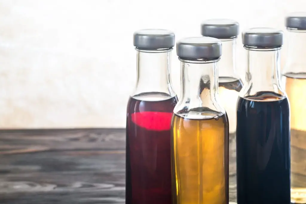 An image of Bottles with different kinds of vinegar.