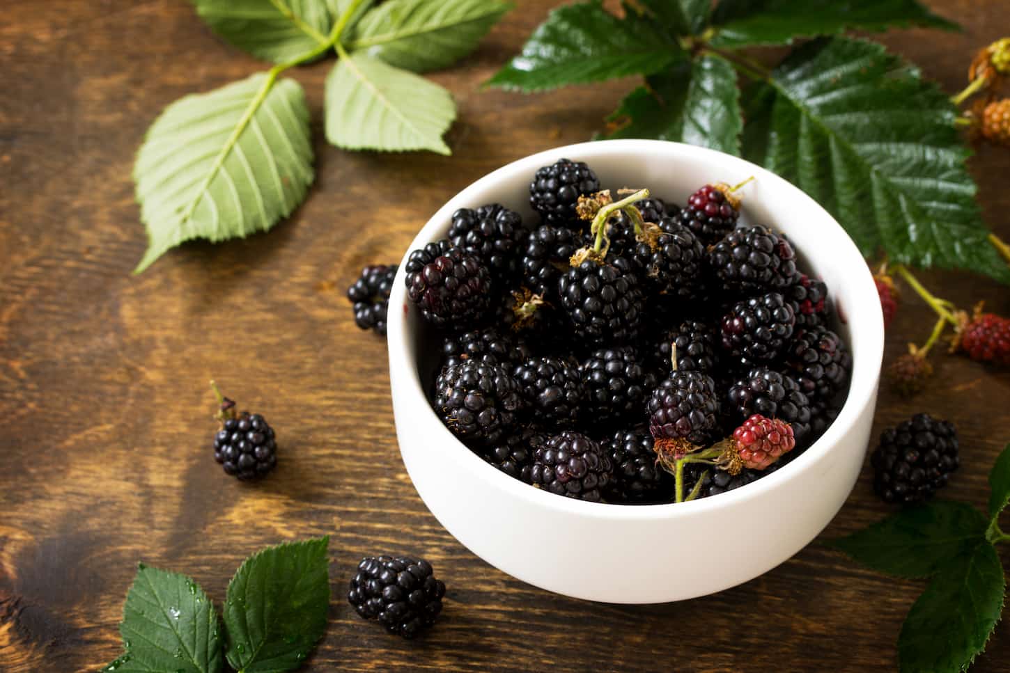 An image of Berries ripe blackberries on a kitchen wooden table.