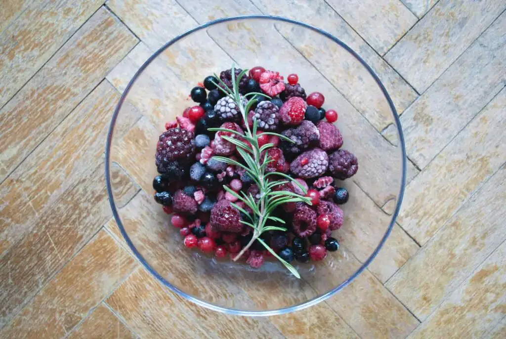 An image of a Glass bowl of frozen berries.
