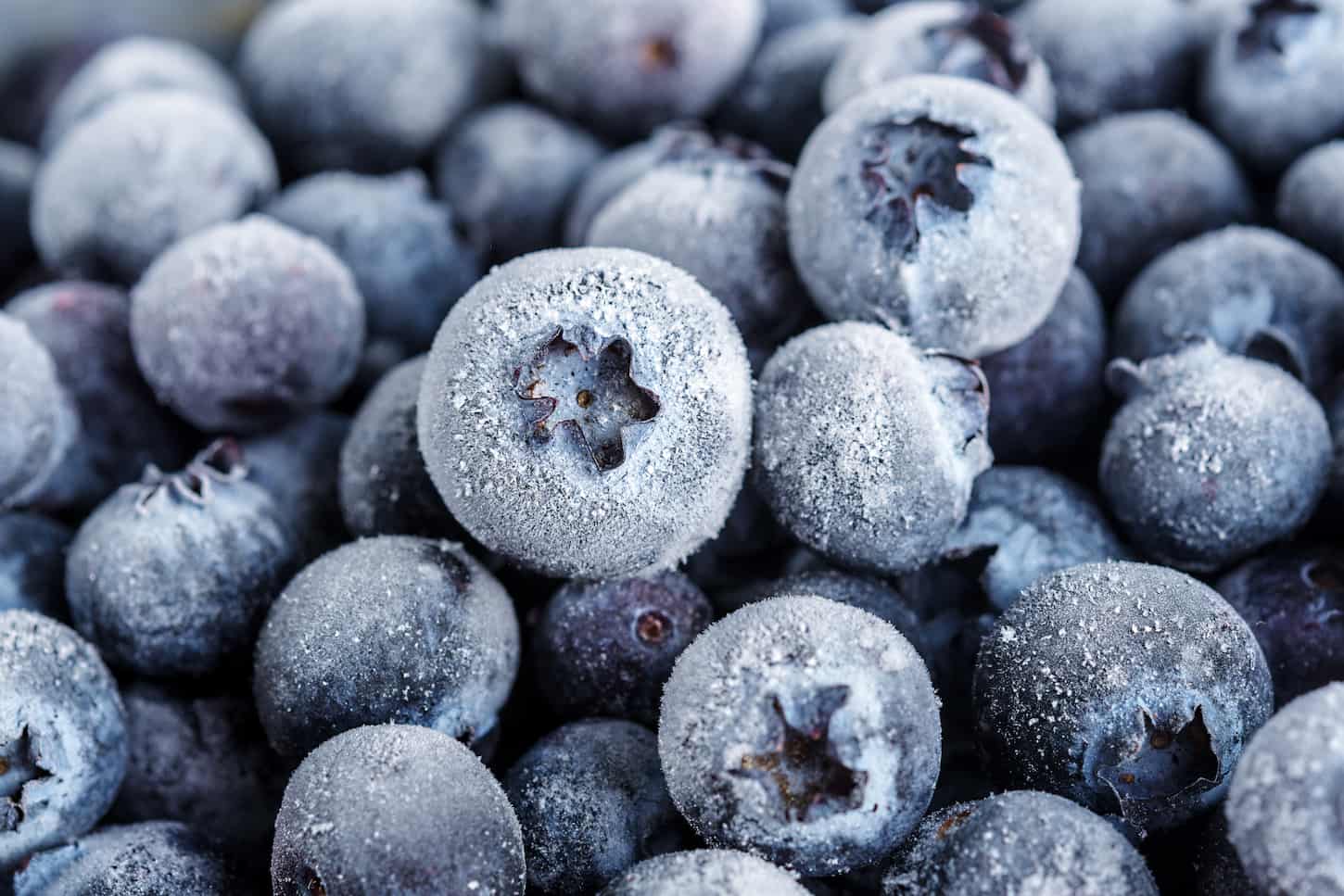 An image of The texture of frozen blueberries. Top view.