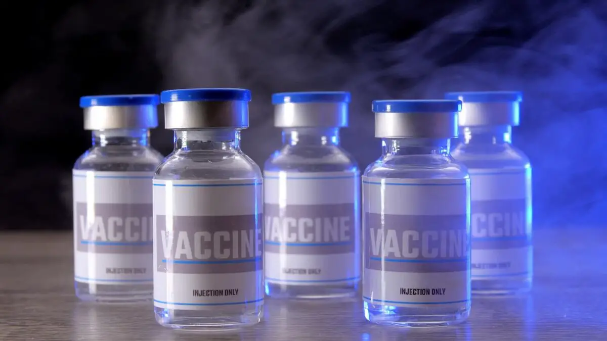 An image of Glass vials for the vaccine in a laboratory. Group of vaccine bottles. Medicine in ampoules.